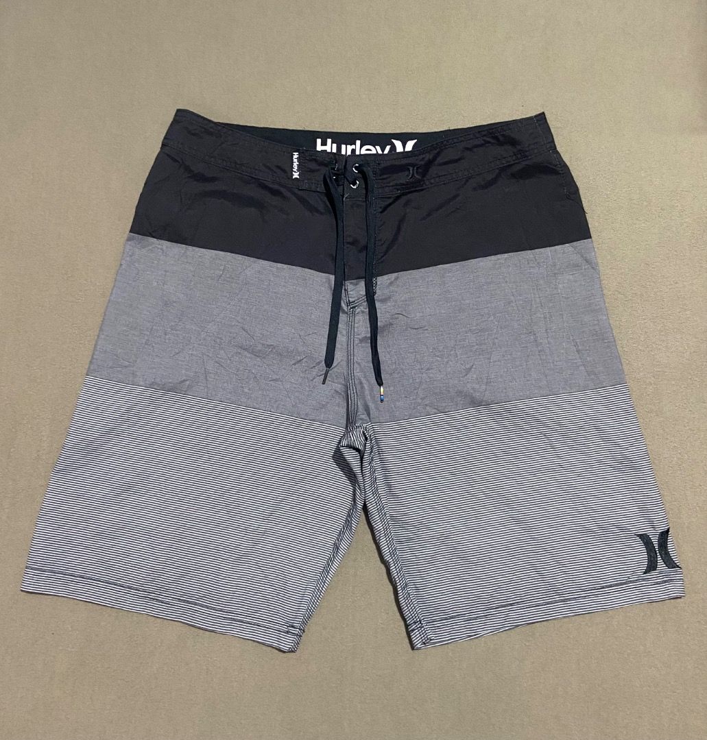 Hurley Board Shorts Size 38 (Category: Swim Trunks & Board Shorts) located in Cebu City. Submitted by badat23 (Listing ID 1469935737, Image 1). Description: - Brand: Hurley - Style: Block stripe pattern (Black, Grey, White) - Size: 38 (printed inside) - Material: Sustainable recycled polyester - Features: Secure drawstring waist with branded ties, convenient back pocket with zip closure - Interior: Clean lining with built-in mesh details - Condit