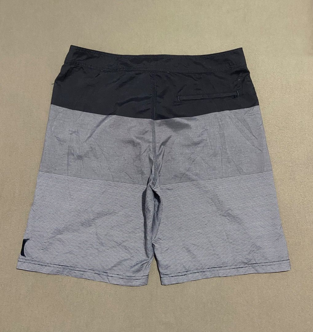 Hurley Board Shorts Size 38 (Category: Swim Trunks & Board Shorts) located in Cebu City. Submitted by badat23 (Listing ID 1469935737, Image 2). Description: - Brand: Hurley - Style: Block stripe pattern (Black, Grey, White) - Size: 38 (printed inside) - Material: Sustainable recycled polyester - Features: Secure drawstring waist with branded ties, convenient back pocket with zip closure - Interior: Clean lining with built-in mesh details - Condit