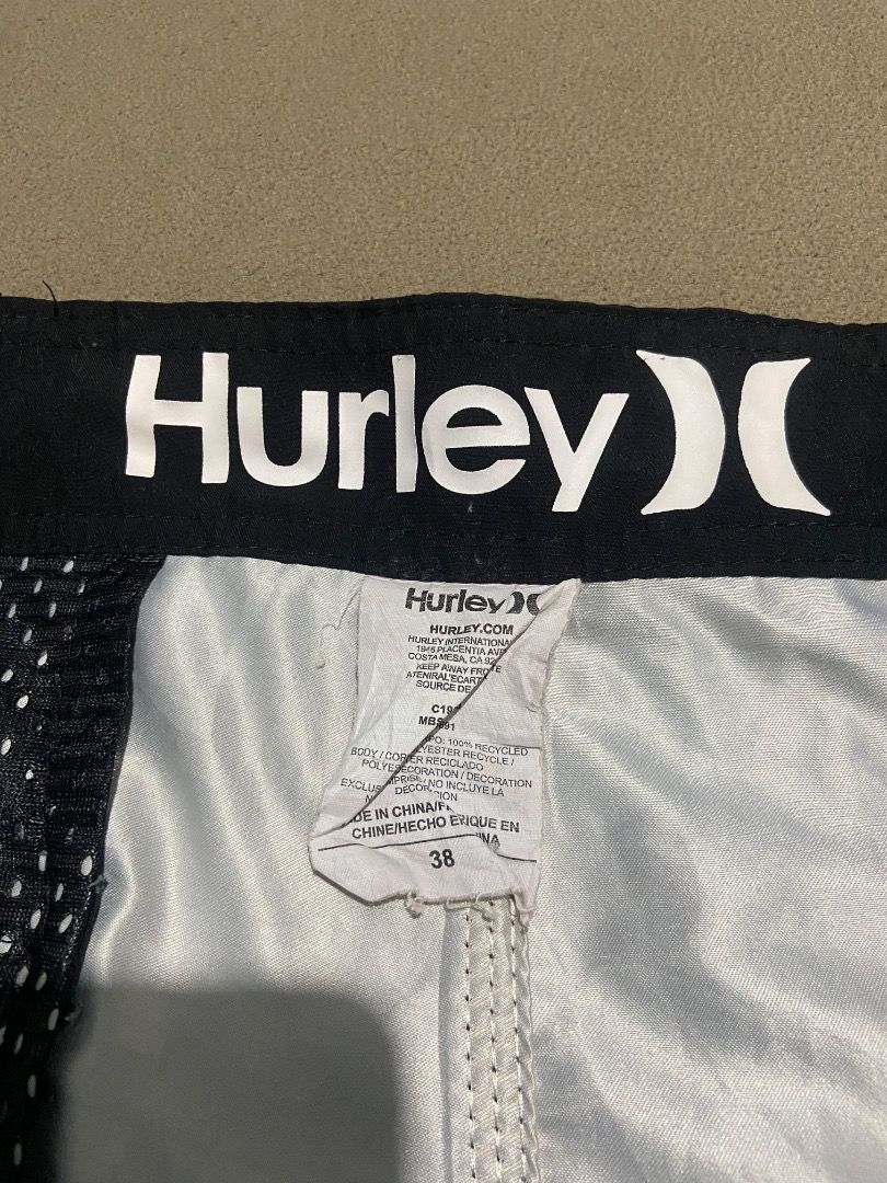 Hurley Board Shorts Size 38 (Category: Swim Trunks & Board Shorts) located in Cebu City. Submitted by badat23 (Listing ID 1469935737, Image 3). Description: - Brand: Hurley - Style: Block stripe pattern (Black, Grey, White) - Size: 38 (printed inside) - Material: Sustainable recycled polyester - Features: Secure drawstring waist with branded ties, convenient back pocket with zip closure - Interior: Clean lining with built-in mesh details - Condit