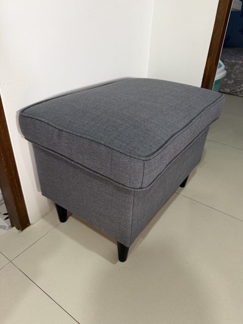 IKEA Storage Ottoman Footstool Dark Grey (with box) (Category: Chairs) located in Cavite. Submitted by jazz.shop (Listing ID 1469838478, Image 1). Description: - Brand/Model: IKEA Storage Stool - Color: Dark grey fabric with dark wooden legs - Function: Lift-up top cushion for hidden storage (great for blankets, pillows, and clutter) - Size: Compact, fits nicely next to a sofa or at the end of a bed - Condition: Clean upholstery with minimal wear