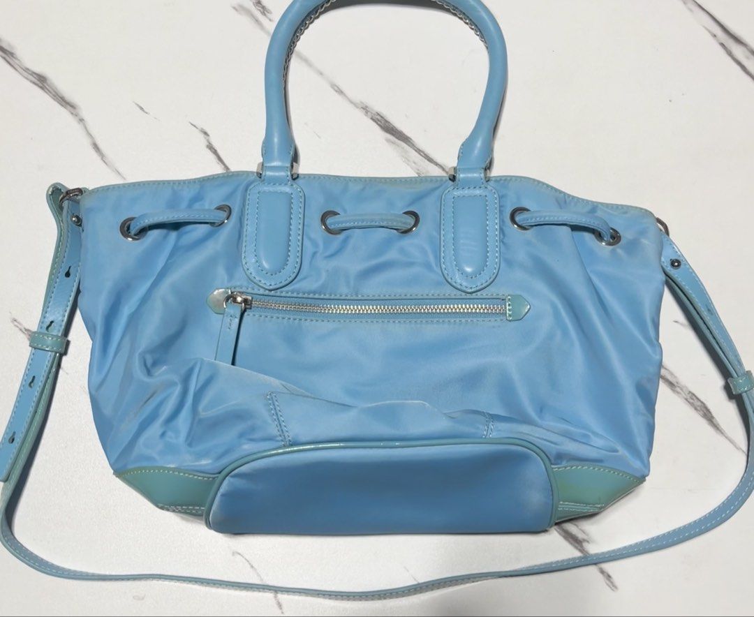 ISCOV Light Blue Nylon Drawstring Bucket Bag (Category: Shoulder Bags) located in General Mariano Alvarez. Submitted by kascade (Listing ID 1469912503, Image 3). Description: - Brand: ISCOV - Style: Drawstring Nylon Bucket Bag / Shoulder Bag - Color: Sky Blue / Teal - Features: Lightweight durable nylon body, sturdy metal chain-linked top handles, adjustable crossbody strap, multiple interior dividers, and magnetic snap closures. ⚠️ CONDITION (Pr