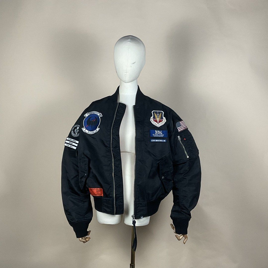 Izzue Industries Type MA-1 Black Bomber Jacket (Category: Coats, Jackets and Outerwear) located in La Trinidad. Submitted by di_tiyak (Listing ID 1469778370, Image 2). Description: - Brand: Izzue Industries - Style: Type MA-1 Bomber Jacket - Color: Black - Details: Military-style chest and sleeve patches, American flag patch on left arm - Features: Zip-up front, classic utility pocket on left sleeve with red pull tab - Fit: Structured fit with ri