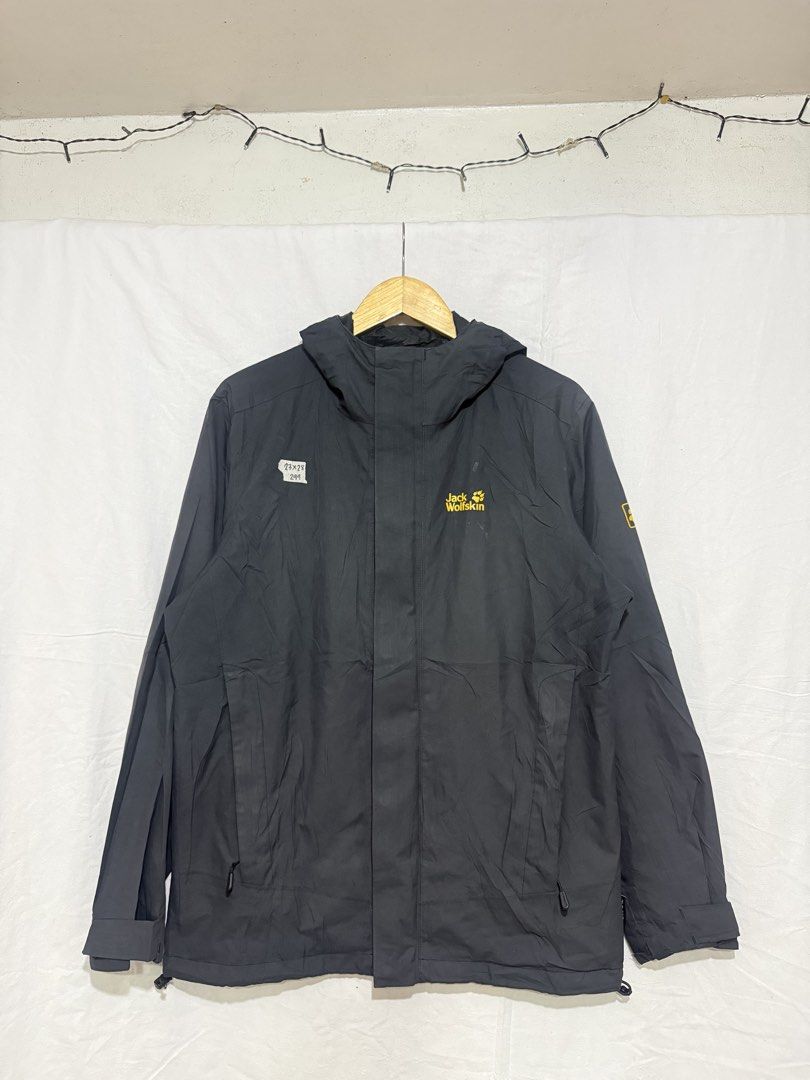Jack Wolfskin Black Hooded Outdoor Jacket (Category: Coats, Jackets and Outerwear) located in Quezon City. Submitted by dapanaaaay (Listing ID 1469927727, Image 1). Description: - Brand: Jack Wolfskin - Color: Classic black with yellow embroidered logo - Features: Full zip with snap-button storm flap, adjustable hood, and zippered side pockets - Fit: Adjustable velcro cuffs and drawstring hem to lock in warmth - Condition: Excellent, ready for hi