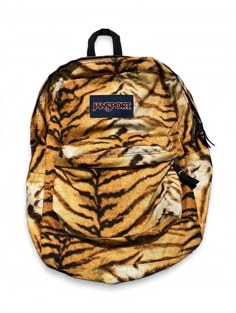 JanSport Tiger Print Backpack (Category: Backpacks) located in Quezon City. Submitted by un0oo (Listing ID 1469923793, Image 1). Description: Bold tiger stripe print all over. Classic JanSport layout with a main compartment and front zipper pocket. Black shoulder straps and back panel. Dark blue label sewn on the front. Durable canvas fabric..