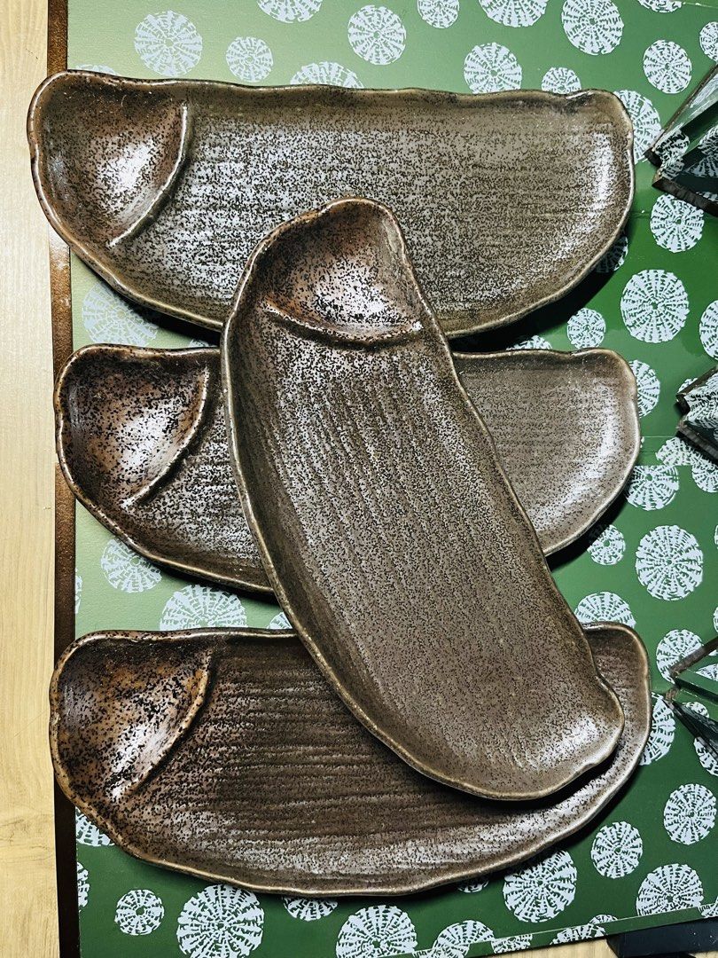 Japanese ceramic sushi plates long rectangular pottery dishes set (Category: Dinnerware & Cutlery) located in Malabon City. Submitted by mgsurplus (Listing ID 1469772171, Image 1). Description: - Set of 11-inch ceramic plates in earthy dark brown and black tones - Features a convenient built-in dipping sauce compartment at one end - Unique textured ribbed pattern along the bottom surface with a speckled finish - Sturdy pottery construction ideal 