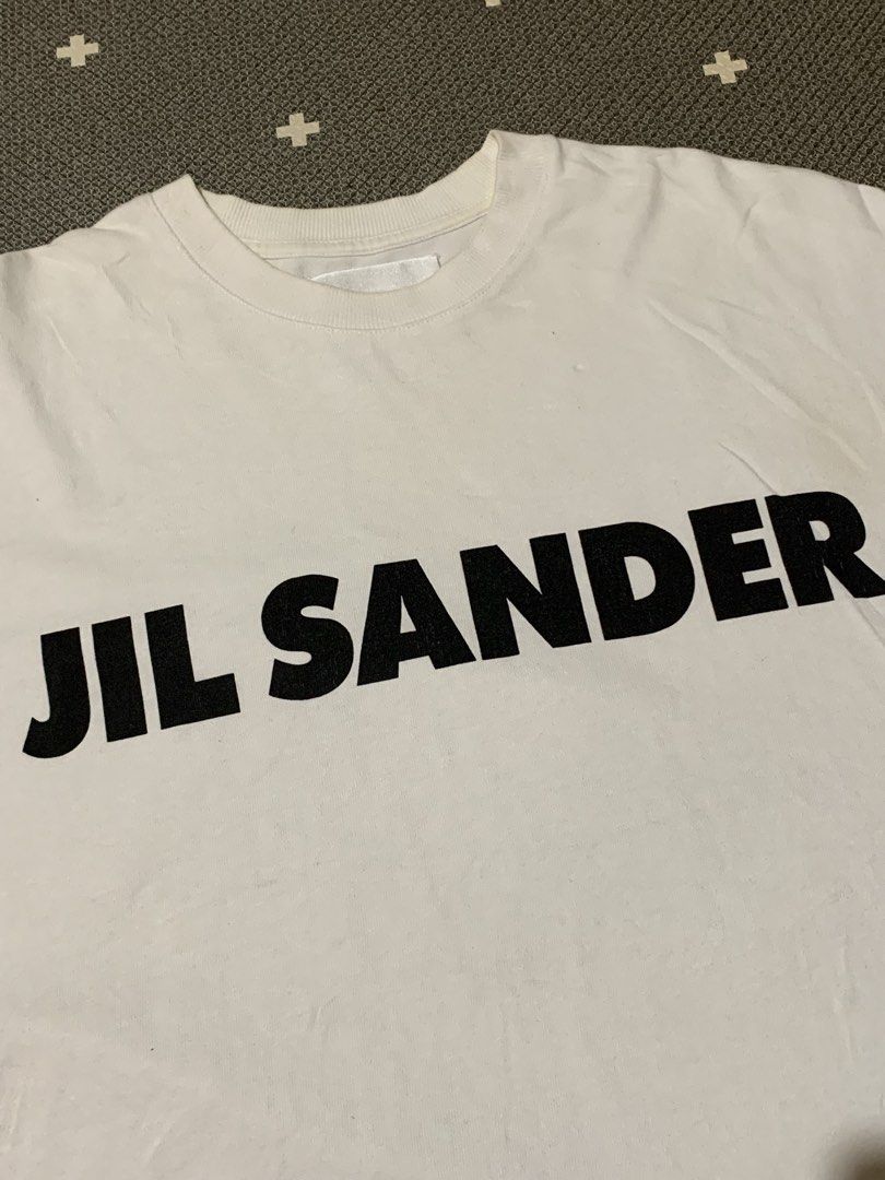 Jil Sander Logo Print Tee (Category: Tshirts & Polo Shirts ) located in Talisay. Submitted by psycho011288 (Listing ID 1469862918, Image 2). Description: 📍JIL SANDER LOGO PRINT TEE 📍💯AUTHENTIC / ORIG 📍Size small on tag ( oversized ) ( In actual dimension ) 📍WIDTH: 24” 📍LENGTH: 30” 📍EXCELLENT USED CONDITION 📍ACTUAL COLOR: White 📍COLOR RATE: 9.8/10 ❌NO ANY ISSUE❌ .