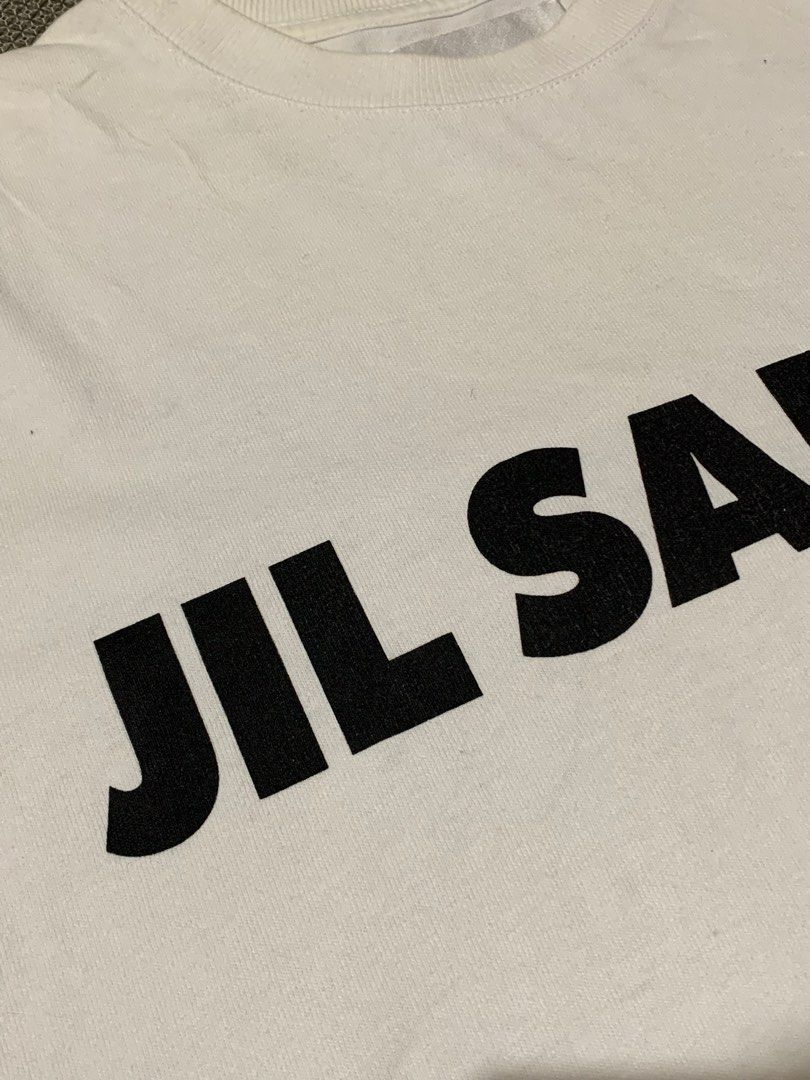 Jil Sander Logo Print Tee (Category: Tshirts & Polo Shirts ) located in Talisay. Submitted by psycho011288 (Listing ID 1469862918, Image 3). Description: 📍JIL SANDER LOGO PRINT TEE 📍💯AUTHENTIC / ORIG 📍Size small on tag ( oversized ) ( In actual dimension ) 📍WIDTH: 24” 📍LENGTH: 30” 📍EXCELLENT USED CONDITION 📍ACTUAL COLOR: White 📍COLOR RATE: 9.8/10 ❌NO ANY ISSUE❌ .