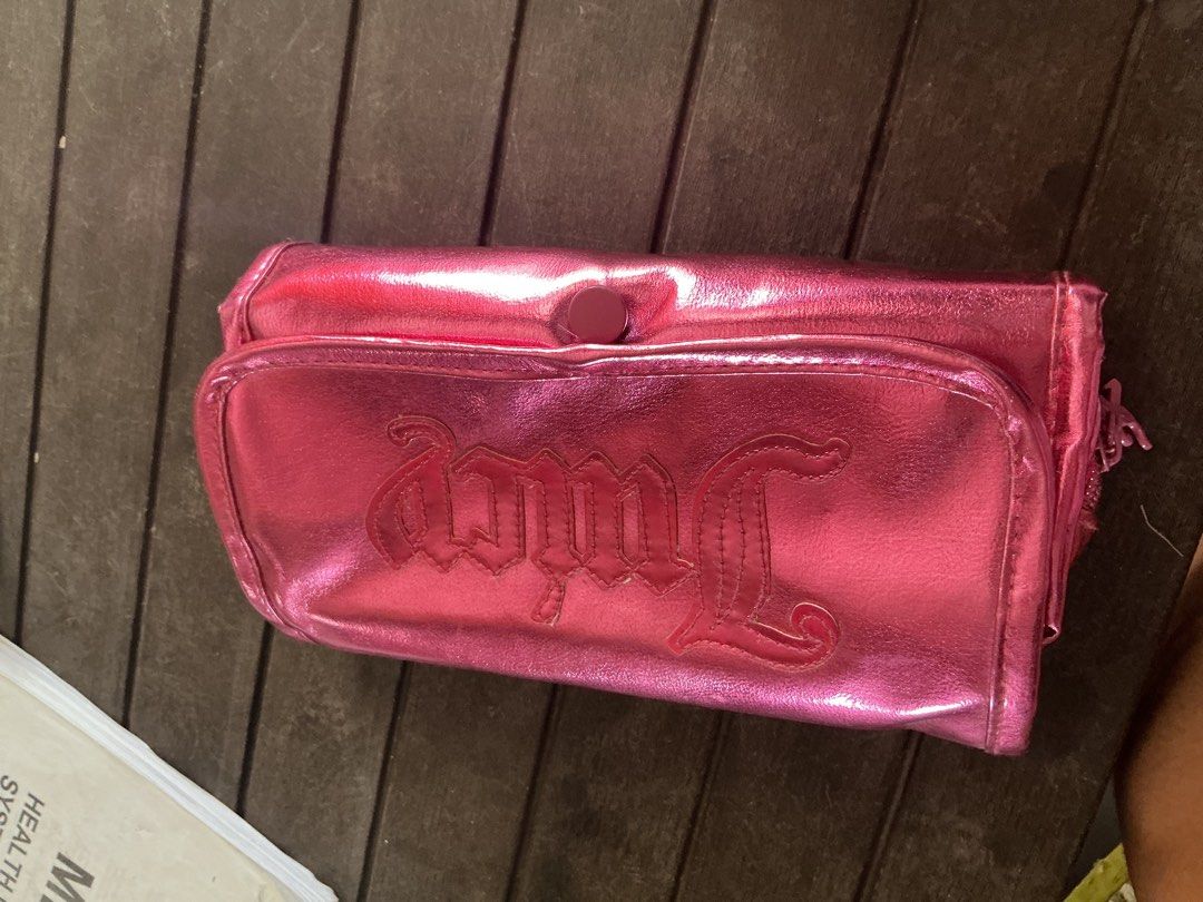 Juicy Couture Metallic Pink Makeup Brush Roll Case Set (Category: Makeup) located in Santa Barbara. Submitted by user82739292 (Listing ID 1469775266, Image 2). Description: - Brand: Juicy Couture - Color: Metallic hot pink with gold hardware - Kasama na brushes - Features: Debossed logo, snap button closure, and matching 'Juicy' chain pull charm - Interior: Includes a full set of makeup brushes with gold handles and a clear protective flap to kee