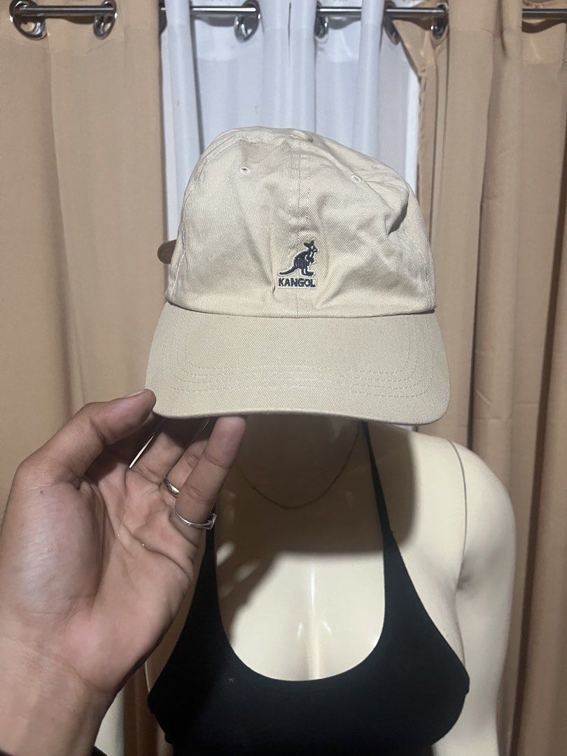 Kangol Beige Baseball Cap with Leather Strap (Category: Caps & Hats) located in Kidapawan. Submitted by azythrift (Listing ID 1469939171, Image 1). Description: - Authentic Kangol baseball cap in classic beige - Iconic embroidered kangaroo logo on the front - Made from durable cotton twill with breathable eyelets - Adjustable brown leather strapback with metallic buckle - Clean interior lining with official branded tag - Versatile everyday access