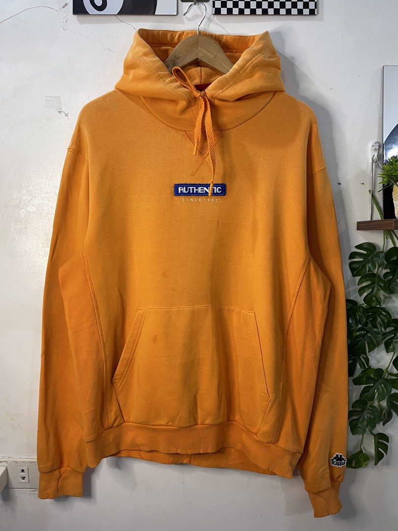 Kappa Authentic Since 1967 Orange Hoodie (Category: Coats, Jackets and Outerwear) located in Cabagan. Submitted by blessingma81004 (Listing ID 1469770021, Image 2). Description: - Brand: Kappa - Color: Vibrant Orange - Size: XL (Width: 25", Length: 28.5") - Material: Heavyweight cotton blend with ribbed side panels - Features: Chest embroidery, drawstring hood, front kangaroo pocket, and sleeve logo patch - Condition: Excellent pre-loved conditio