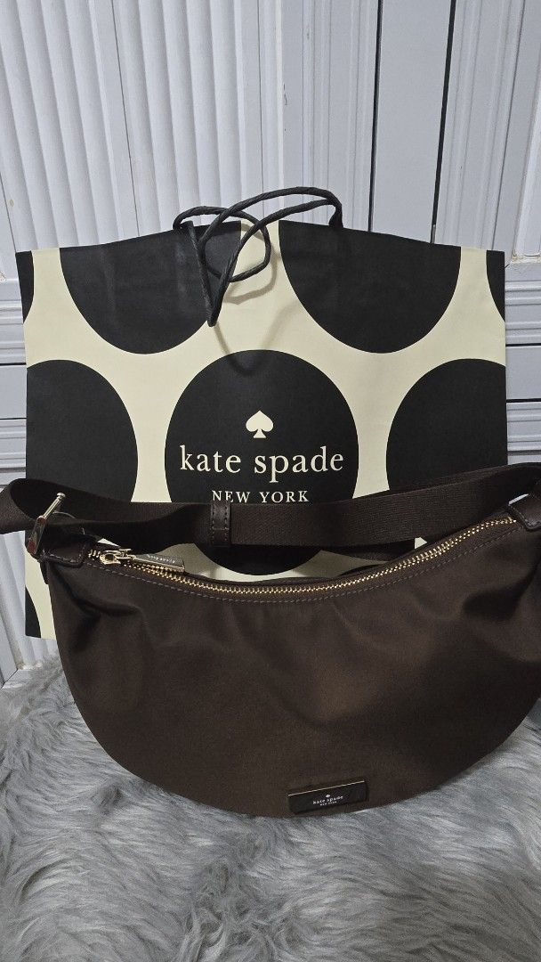 Kate Spade Carter Mini Sling Crossbody Bag Hot Fudge (Category: Cross-body Bags) located in Cabanatuan. Submitted by belle_1013 (Listing ID 1469936607, Image 3). Description: - Brand: Kate Spade - Style: Carter Mini Sling Crossbody Bag - Color: Hot Fudge Brown - Material: Smooth nylon with matching adjustable fabric strap and gold hardware - Closure: Zip top with front metal brand plaque - Condition: Brand new, never used, fresh from store with o