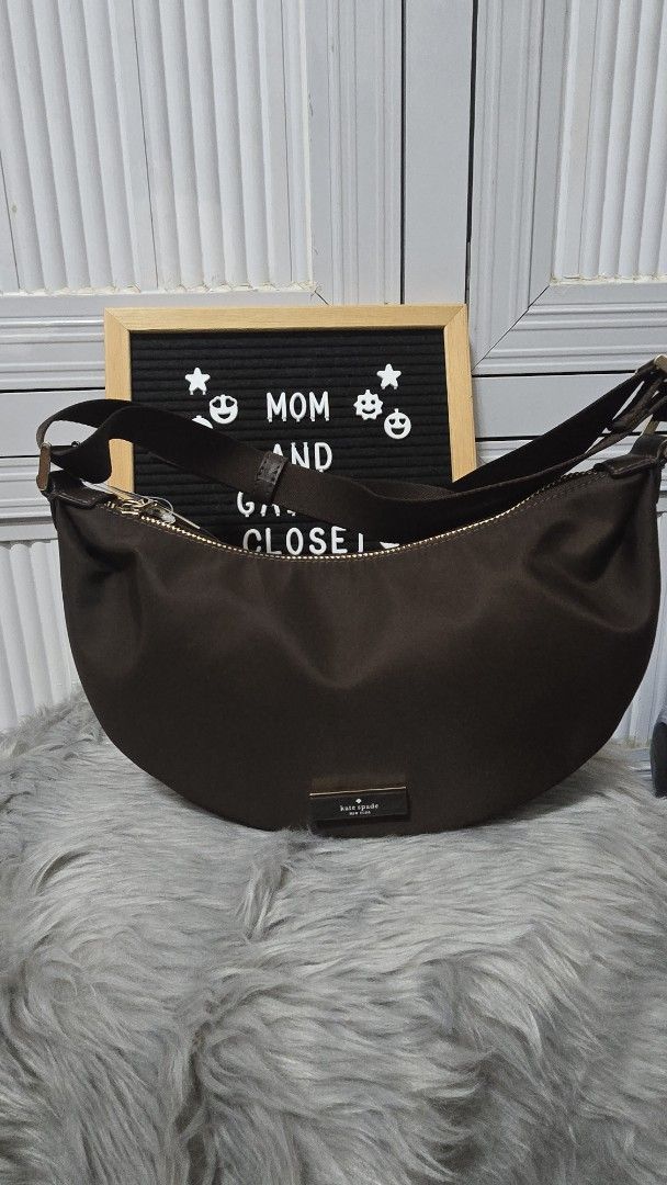 Kate Spade Carter Mini Sling Crossbody Bag Hot Fudge (Category: Cross-body Bags) located in Cabanatuan. Submitted by belle_1013 (Listing ID 1469936607, Image 1). Description: - Brand: Kate Spade - Style: Carter Mini Sling Crossbody Bag - Color: Hot Fudge Brown - Material: Smooth nylon with matching adjustable fabric strap and gold hardware - Closure: Zip top with front metal brand plaque - Condition: Brand new, never used, fresh from store with o