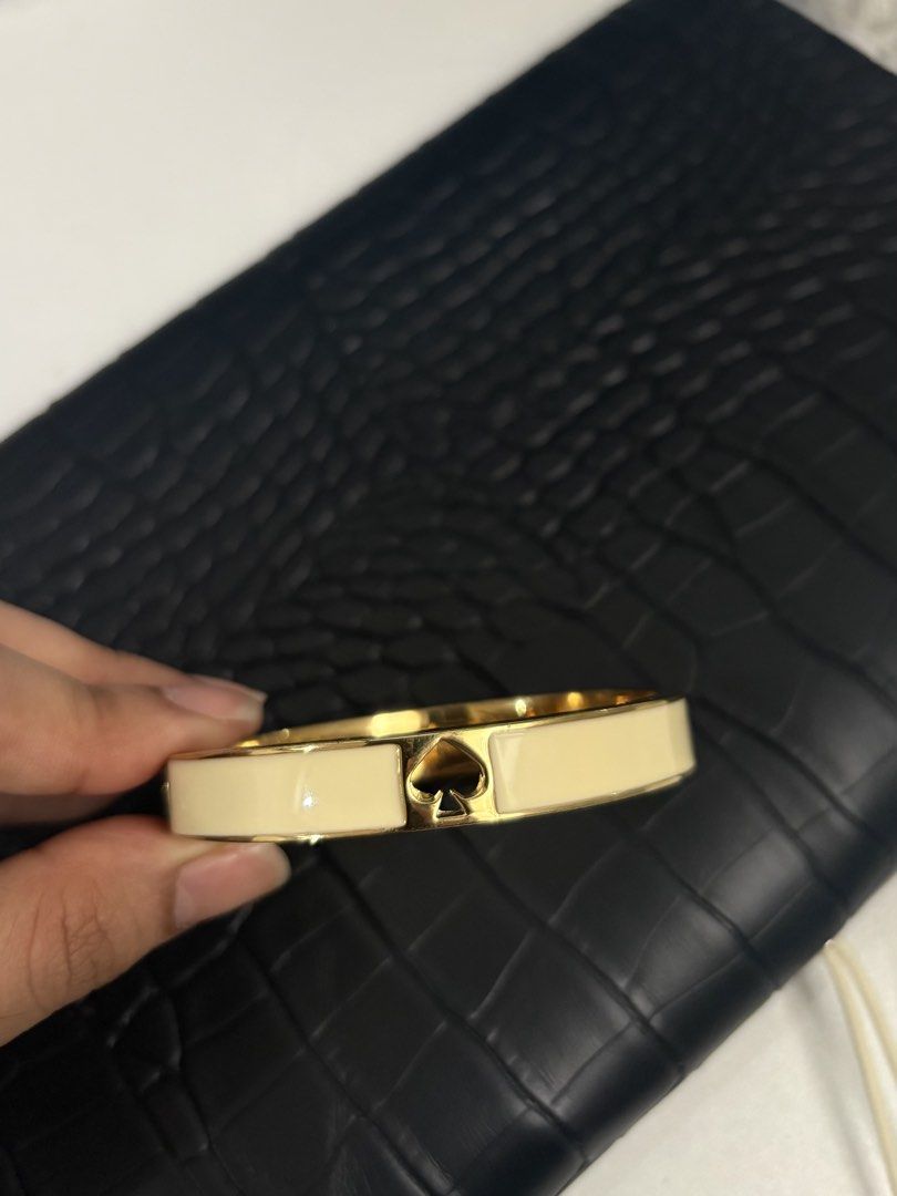 Kate Spade Gold Spade Bangle Bracelet Cream (Category: Bracelets) located in Paranaque City. Submitted by yannas_closet (Listing ID 1469836072, Image 1). Description: - Cream enamel bangle with elegant gold-tone hardware - Cutout spade logo right in the center.