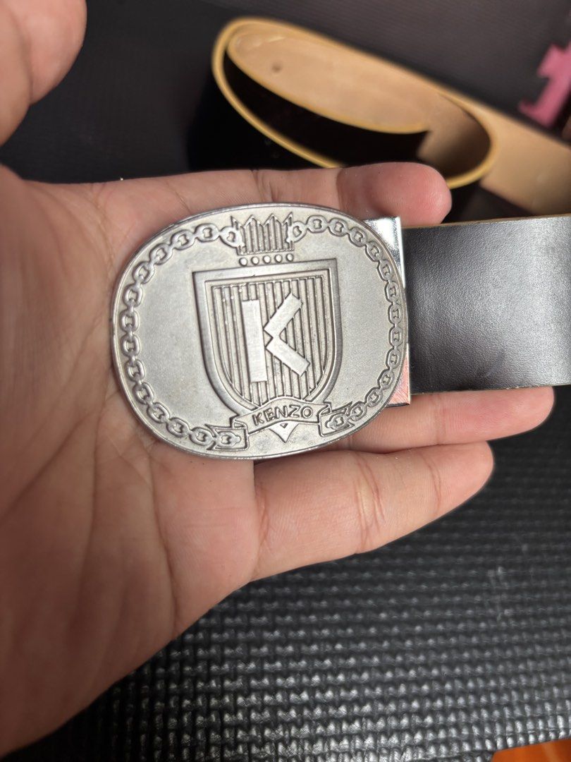 KENZO Logo Buckle Leather Belt (Category: Belts) located in Caloocan City. Submitted by neweagle-424b (Listing ID 1469812344, Image 3). Description: ( 43 ) - inches length - Brand: KENZO - Color: Dark Brown - Material: Genuine Leather - Hardware: Silver-tone crest buckle with 'K' initial - Details: Embossed branding and serial numbers on the inner strap - Style: Classic and versatile for casual or formal wear - Condition: Sturdy and well-maintain
