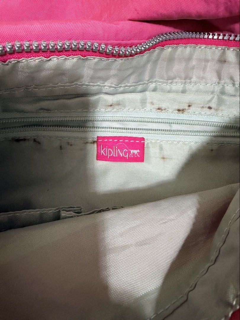 Kipling Pink Crossbody Bag with Monkey Keychain (Category: Cross-body Bags) located in Cavite. Submitted by mgd.blessed (Listing ID 1469911141, Image 3). Description: - Authentic Kipling crossbody bag in a vibrant bright pink shade - Includes the iconic furry pink monkey keychain - Features an adjustable pink fabric strap and front flap pocket with secure zipper closure - Silver-tone hardware accents - Interior has grey fabric lining with the off