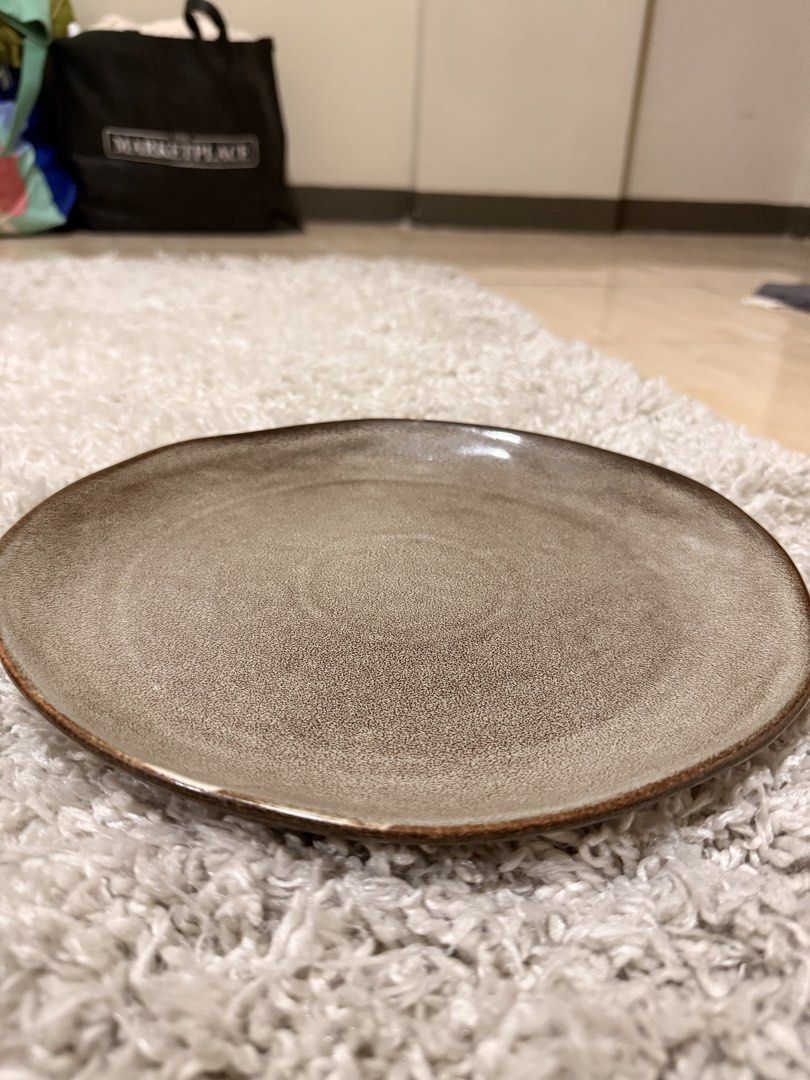 Kitchen Plus Ceramic Plate Dinnerware Brown Speckled (Category: Dinnerware & Cutlery) located in Mandaluyong City. Submitted by riz_040521 (Listing ID 1469798410, Image 1). Description: - Brand: Kitchen Plus - Color/Finish: Earthy brown with a unique speckled glaze - Design: Rustic aesthetic featuring subtle variations along the rim - Material: Durable and sturdy ceramic build - Authenticity: Base stamped with the official brand logo - Ideal for 