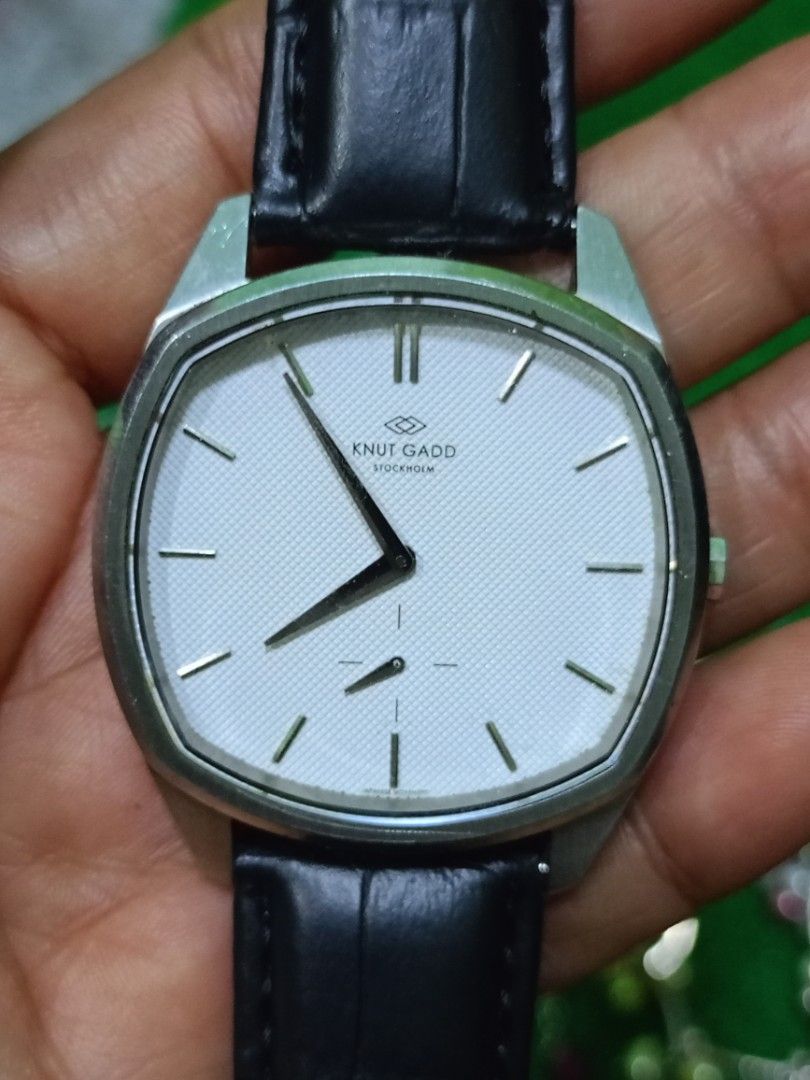 Knut Gadd Stockholm Watch (Category: Men's Watches) located in Bacoor. Submitted by bibelot03 (Listing ID 1469939310, Image 1). Description: - Brand/Model: Knut Gadd Stockholm Men's Dress Watch - Dial: White textured dial with silver hands, index markers, and small seconds sub-dial - Case: Silver-toned with a unique cushion shape and clean crystal - Strap: Black leather with embossed crocodile pattern and standard pin buckle - Condition: Nice ove