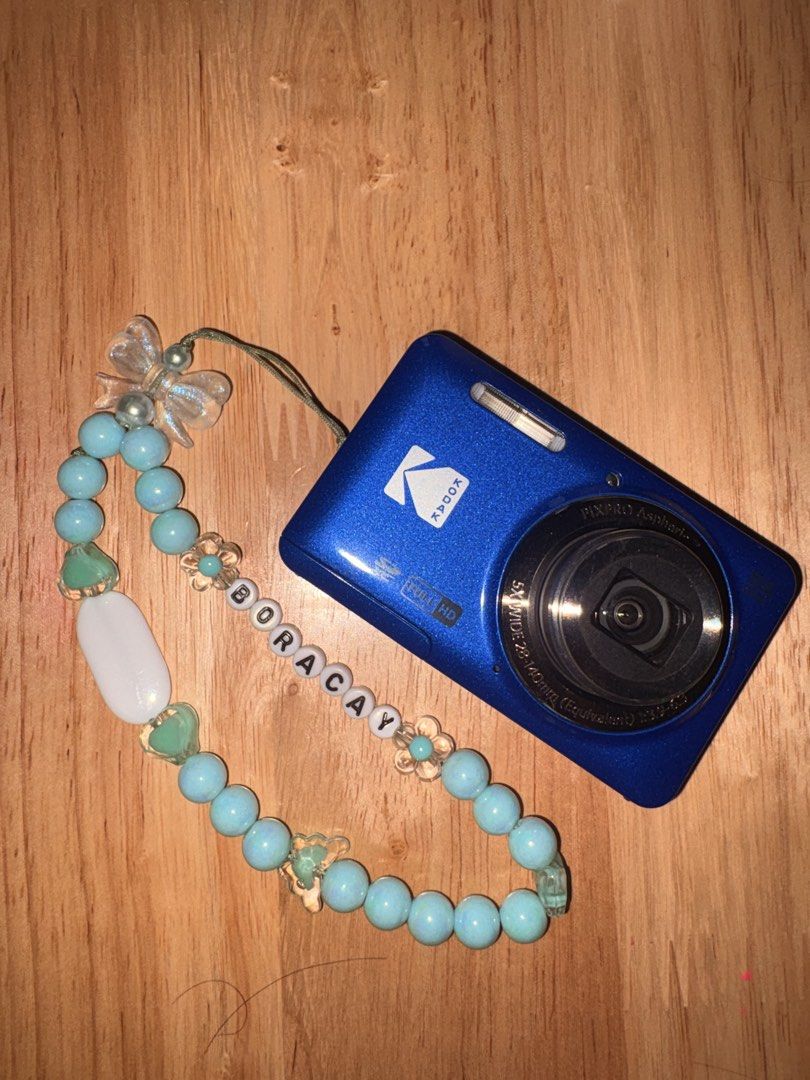 Kodak PixPro FZ55 Digital Camera Blue (Category: Cameras) located in Marikina City. Submitted by jas.lin (Listing ID 1469843488, Image 3). Description: - Model: Kodak PixPro FZ55 Digital Camera (Blue) - Resolution: 16 Megapixels with 5x optical zoom and 28mm wide angle - Design: Pocket-friendly, compact point-and-shoot - Power: Runs on a rechargeable lithium-ion battery - Inclusions: Original box and a custom handmade 'BORACAY' beaded wrist strap