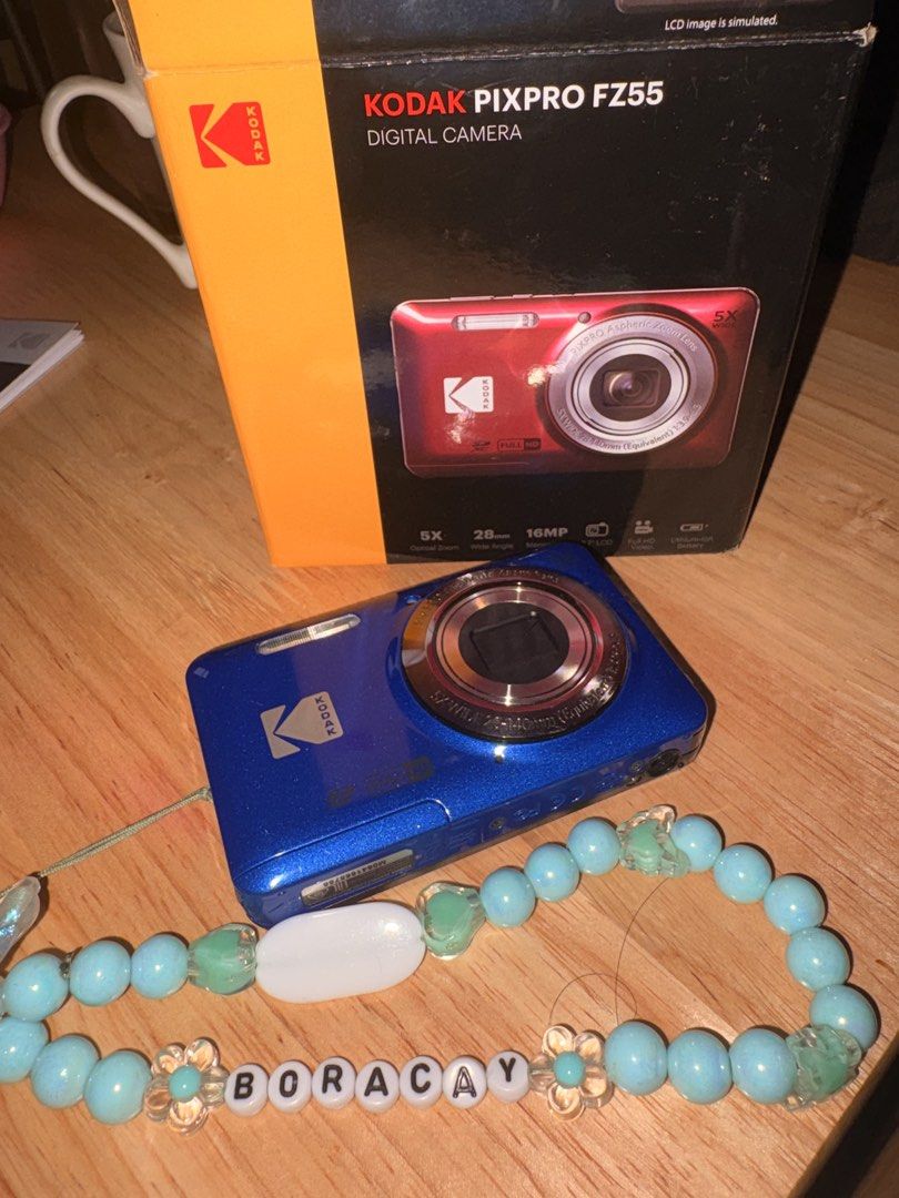 Kodak PixPro FZ55 Digital Camera Blue (Category: Cameras) located in Marikina City. Submitted by jas.lin (Listing ID 1469843488, Image 1). Description: - Model: Kodak PixPro FZ55 Digital Camera (Blue) - Resolution: 16 Megapixels with 5x optical zoom and 28mm wide angle - Design: Pocket-friendly, compact point-and-shoot - Power: Runs on a rechargeable lithium-ion battery - Inclusions: Original box and a custom handmade 'BORACAY' beaded wrist strap