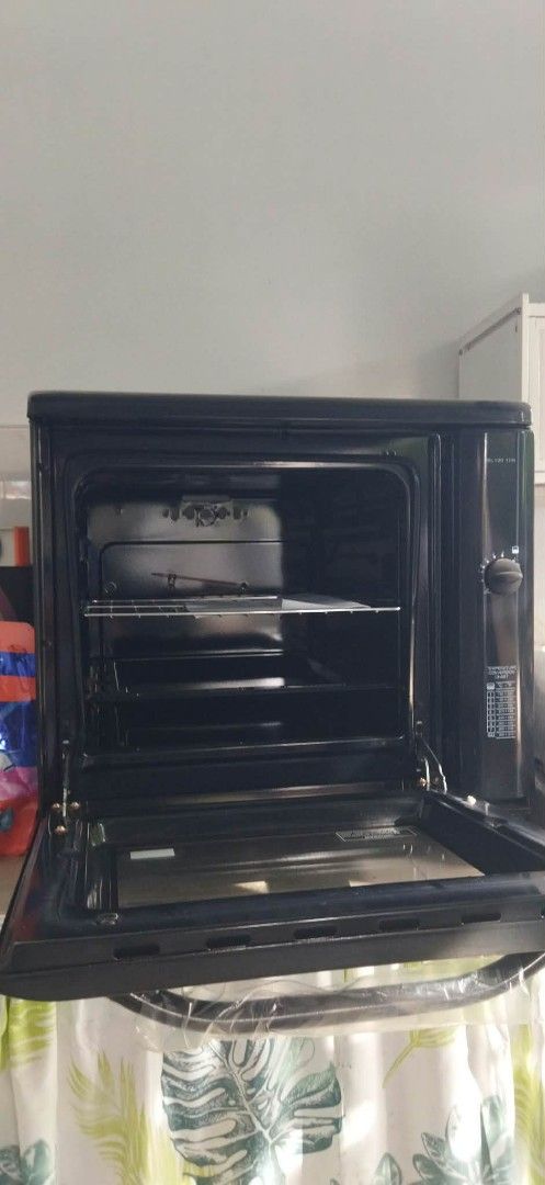La Germania SL100 10B Electric Oven (Category: Ovens & Toasters) located in Manila. Submitted by charieeris13732 (Listing ID 1469833634, Image 3). Description: - Brand: La Germania (Model SL100 10B) - Color/Design: Sleek black finish with glass door - Features: Built-in temperature conversion chart on side control panel - Inclusions: Wire rack, product manual, and original box - Manufacturer: General Heat Corporation (under license from Bertazzon