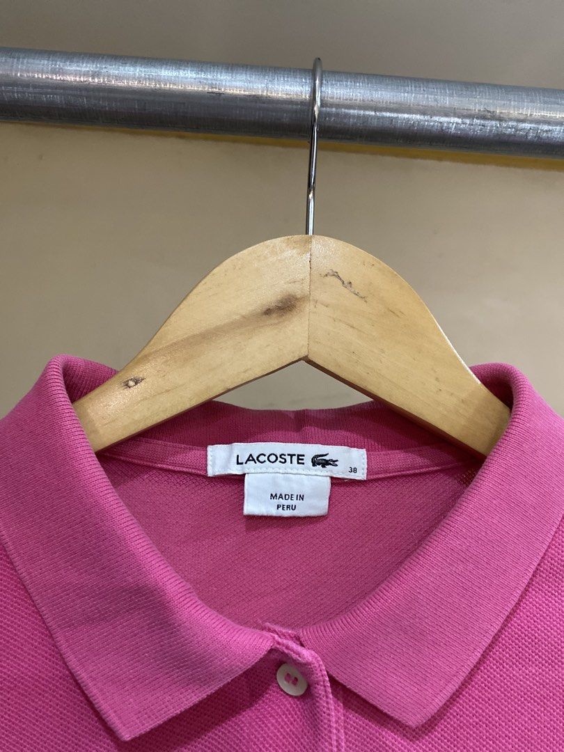 Lacoste Pink Polo Shirt Size 38 (Category: Tshirts & Polo Shirts ) located in Rizal. Submitted by channzy (Listing ID 1469821983, Image 2). Description: - Brand: Lacoste - Style: Classic cotton petit piqué polo shirt - Color: Vibrant pink - Size: 38 (marked on collar tag) - Details: Signature embroidered green crocodile logo, two-button placket, ribbed collar and armbands - Origin: Made in Peru - Condition: Clean inside and out with clear inner c