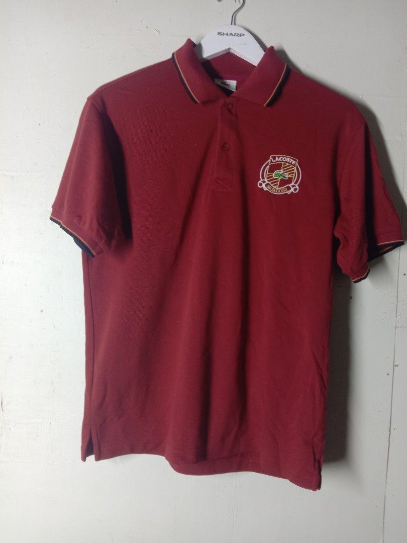 Lacoste Polo Shirt Maroon with Crest Logo (Category: Tshirts & Polo Shirts ) located in Talavera. Submitted by cookiess. (Listing ID 1469891012, Image 1). Description: - Color: Maroon - Fit: Classic fit - Details: Special embroidered crest logo on left chest - Accents: Contrast piping on collar and sleeve cuffs - Design: Two-button placket, ribbed collar, and side slits at the hem - Sleeves: Short sleeves.