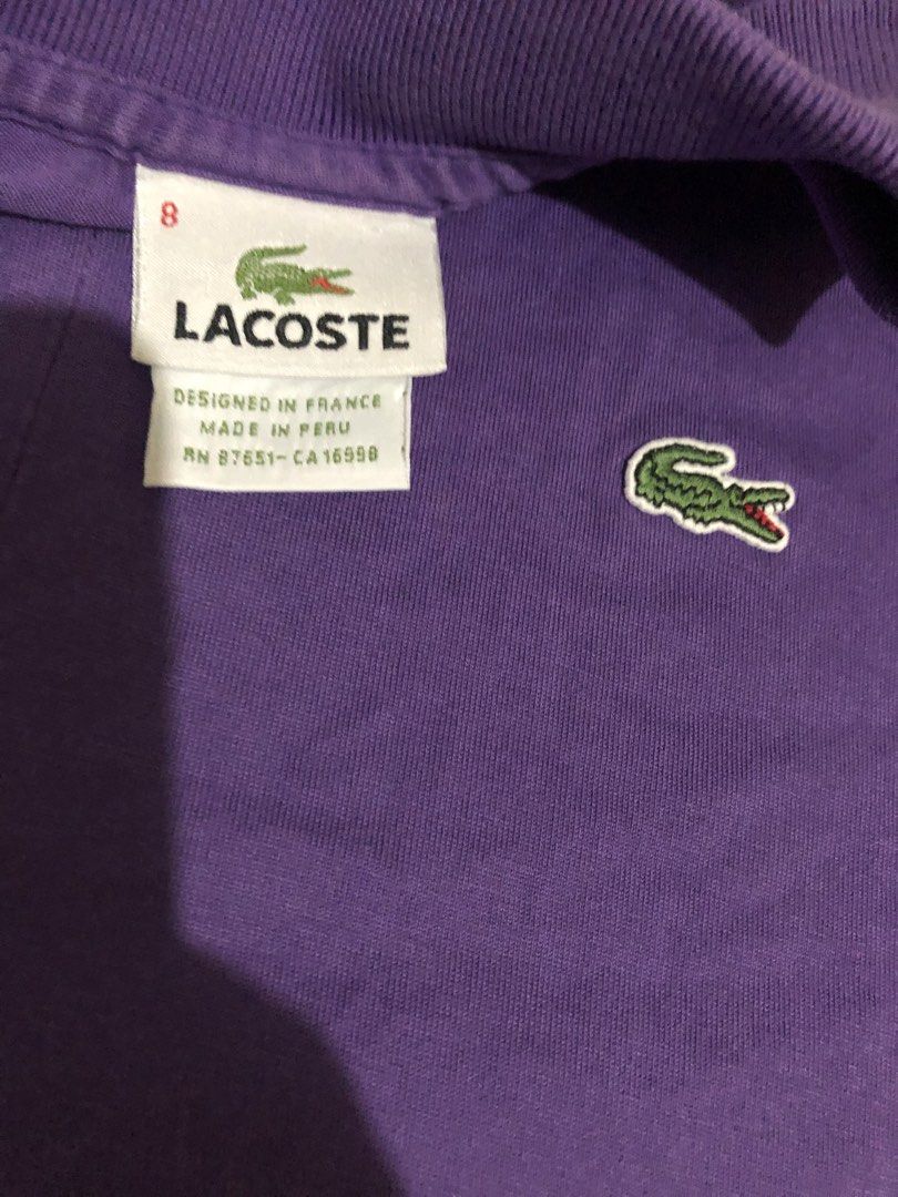 Lacoste Purple Polo Shirt Size 8 (Category: Tshirts & Polo Shirts ) located in Manila. Submitted by gobvs222 (Listing ID 1469926809, Image 2). Description: - Brand: Lacoste - Color: Vibrant Purple - Size: Tagged Size 8 - Material: Comfortable 100% Cotton - Origin: Made in Peru (Designed in France) - Features: Short sleeves, classic button placket, embroidered crocodile logo on chest - Condition: Clean collar, neat stitching, excellent for casual 