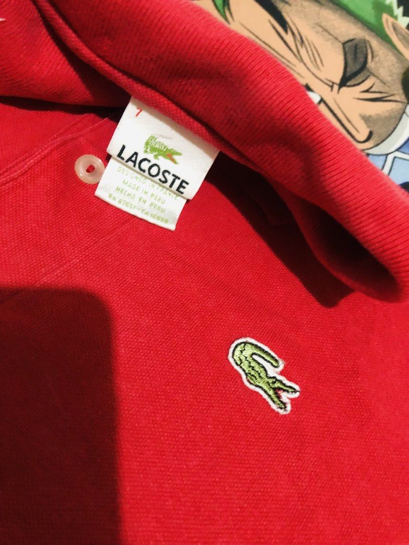 Lacoste Red Polo Shirt Size 7 (Category: Tshirts & Polo Shirts ) located in Manila. Submitted by gobvs222 (Listing ID 1469926776, Image 2). Description: - Brand: Lacoste - Color: Bright red - Size: 7 - Material: 100% Cotton pique (breathable and comfortable) - Design: Classic two-button placket, collar, and iconic embroidered green crocodile logo on the chest - Origin: Made in Peru - Condition: Great classic piece for casual wear.