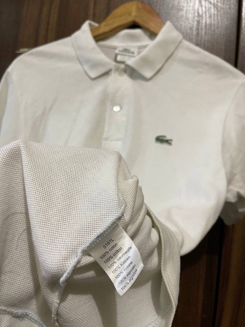 Lacoste White Polo Shirt (Category: Tshirts & Polo Shirts ) located in Manila. Submitted by poloclubdept (Listing ID 1469895205, Image 3). Description: - Brand: Lacoste - Color: Classic White - Material: 100% Cotton (Pique texture) - Fit: Classic fit with short sleeves and button placket - Details: Iconic embroidered green crocodile logo on the chest - Origin: Designed in France, made in Peru - Condition: Clean fabric, excellent everyday casual b