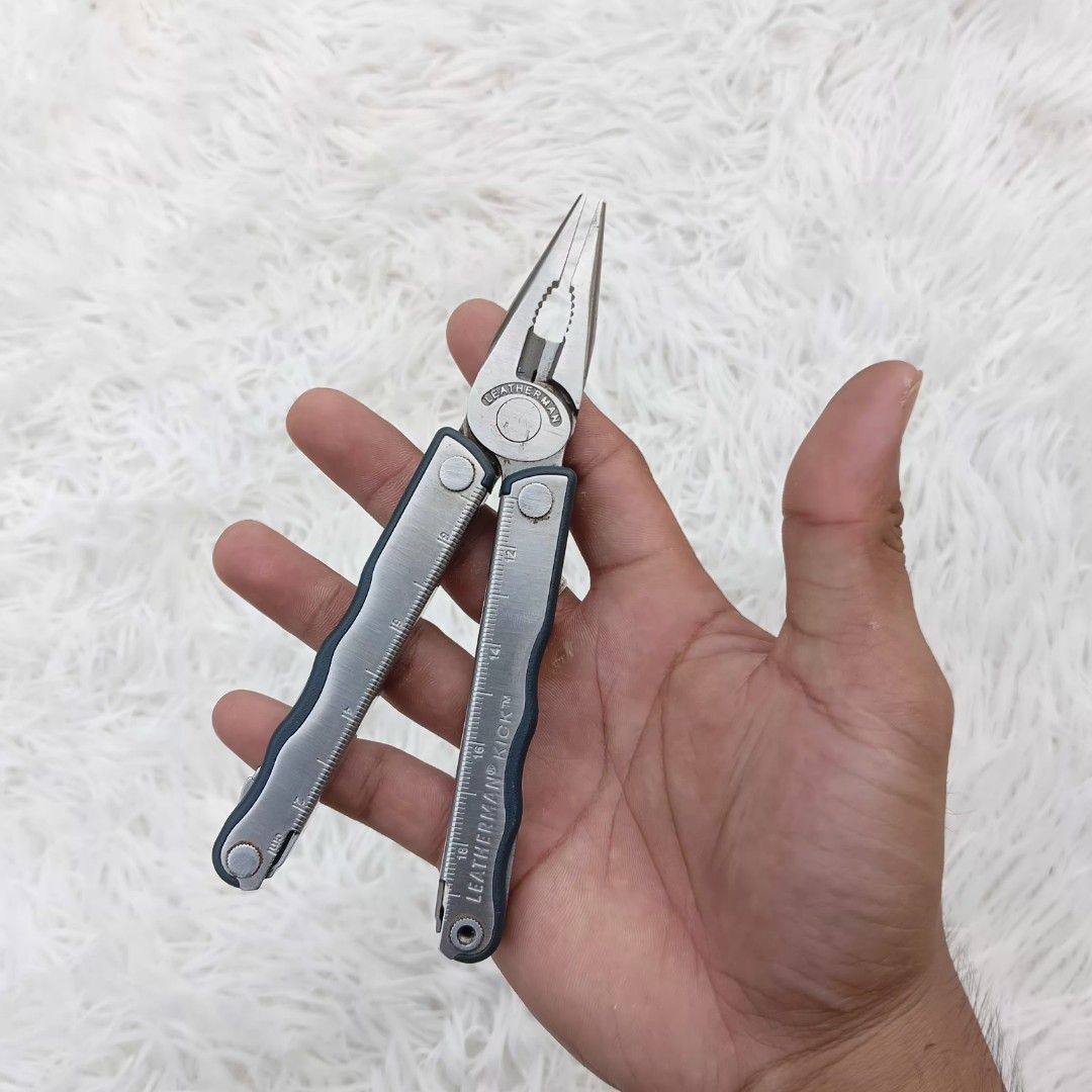 Leatherman Kick Multi-Tool (Category: Hiking & Camping) located in Gattaran. Submitted by thrift_wiseph (Listing ID 1469857341, Image 2). Description: Leatherman Kick multi-tool with pliers, knife blade, screwdrivers, and bottle opener. Integrated ruler on the handles. Shows minor wear and some tarnishing on the tools from regular use. Solid folding action and locks work fine. Handy everyday carry for quick fixes, camping, or keeping in the car..