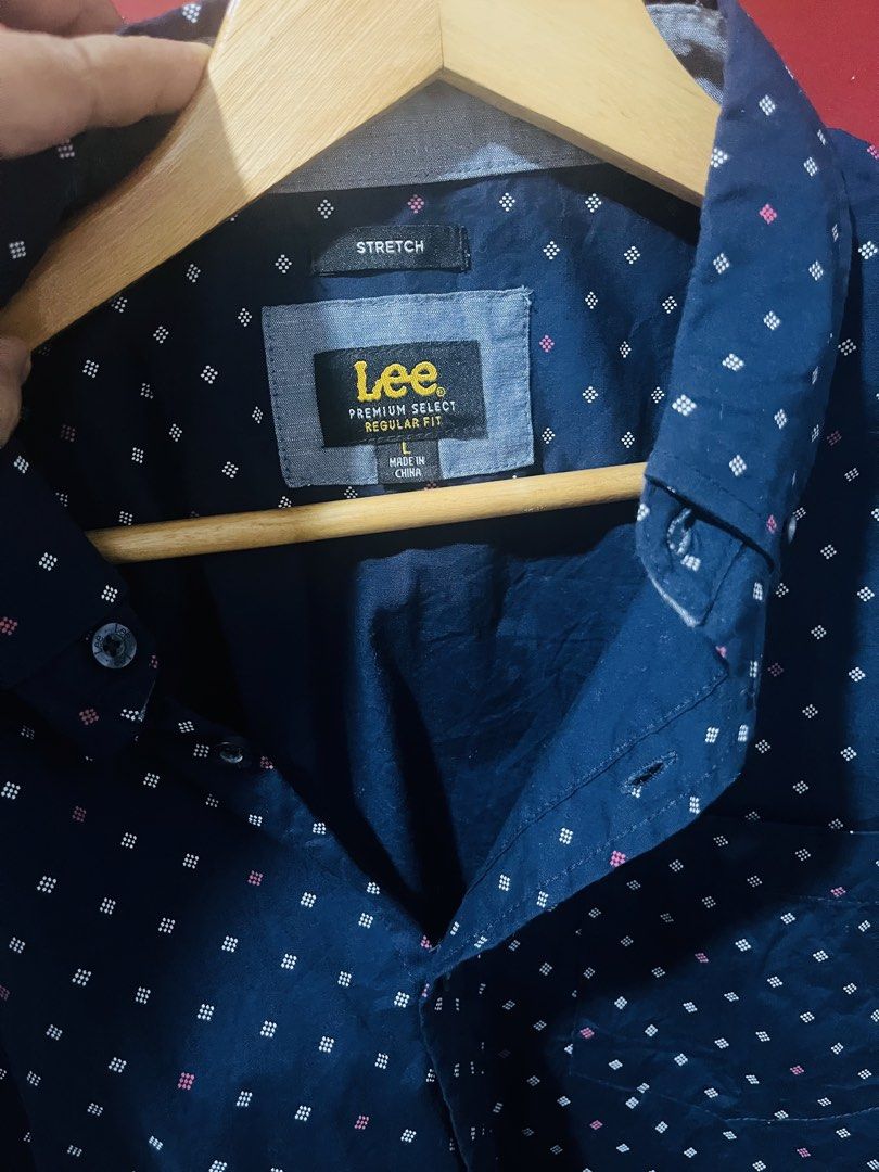 Lee short-sleeve button-up shirt (Category: Formal Shirts) located in Quezon City. Submitted by wacpon_061972 (Listing ID 1469879483, Image 2). Description: A navy blue short-sleeve button-up shirt with a geometric micro-dot pattern and a Lee Premium Select label. (W-24/L-30).