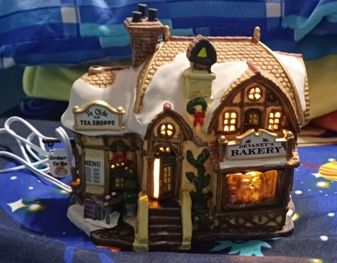 Lemax Bakery (Category: Other Home Decor) located in Pasig City. Submitted by dolliesandpastels (Listing ID 1469779692, Image 1). Description: Title: Devaney's Bakery Description: Beneath a snow-covered roof, Devaney's Bakery features a large, well-lit front window that reveals a charming interior scene. A detailed menu and other helpful signs line the exterior walls. This rustic bakery will fit right into any snowy Christmas Village scene. Appro