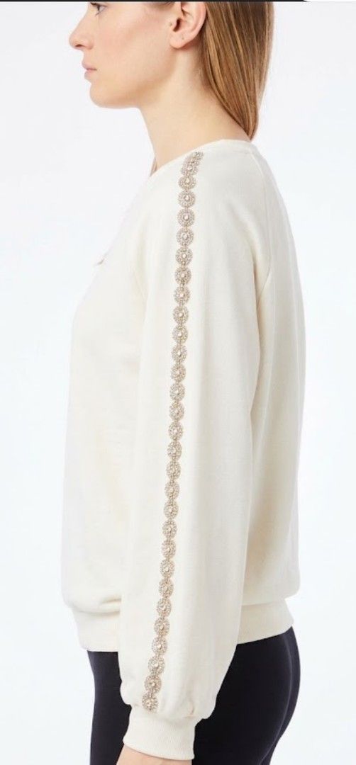 LesBabies Elegant Gemstone Embellished Top (Category: Coats, Jackets and Outerwear) located in Quezon City. Submitted by chph3rd (Listing ID 1469764088, Image 2). Description: - Color: White - Style: Long-sleeve sweatshirt with rhinestone and pearl trim on neckline and outer sleeves - Material: Soft cotton blend - Details: Ribbed crewneck, cuffs, and hem - Condition: Excellent, clean with no stains or damage .
