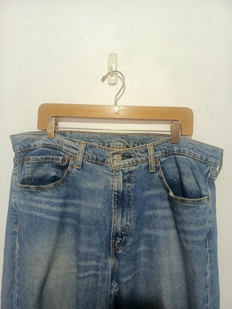 Levi's 511 Slim Fit Jeans W36 L34 (Category: Jeans) located in Baguio. Submitted by miisthyshop.ph (Listing ID 1469909577, Image 3). Description: - Brand: Levi's 511 Slim Fit Jeans - Size: W36 L34 - Color: Mid wash blue with faded details on thighs and knees - Closure: Classic button fly - Details: Five-pocket styling, leather back patch, and signature red tab - Material: Sturdy, comfortable denim ideal for everyday wear.