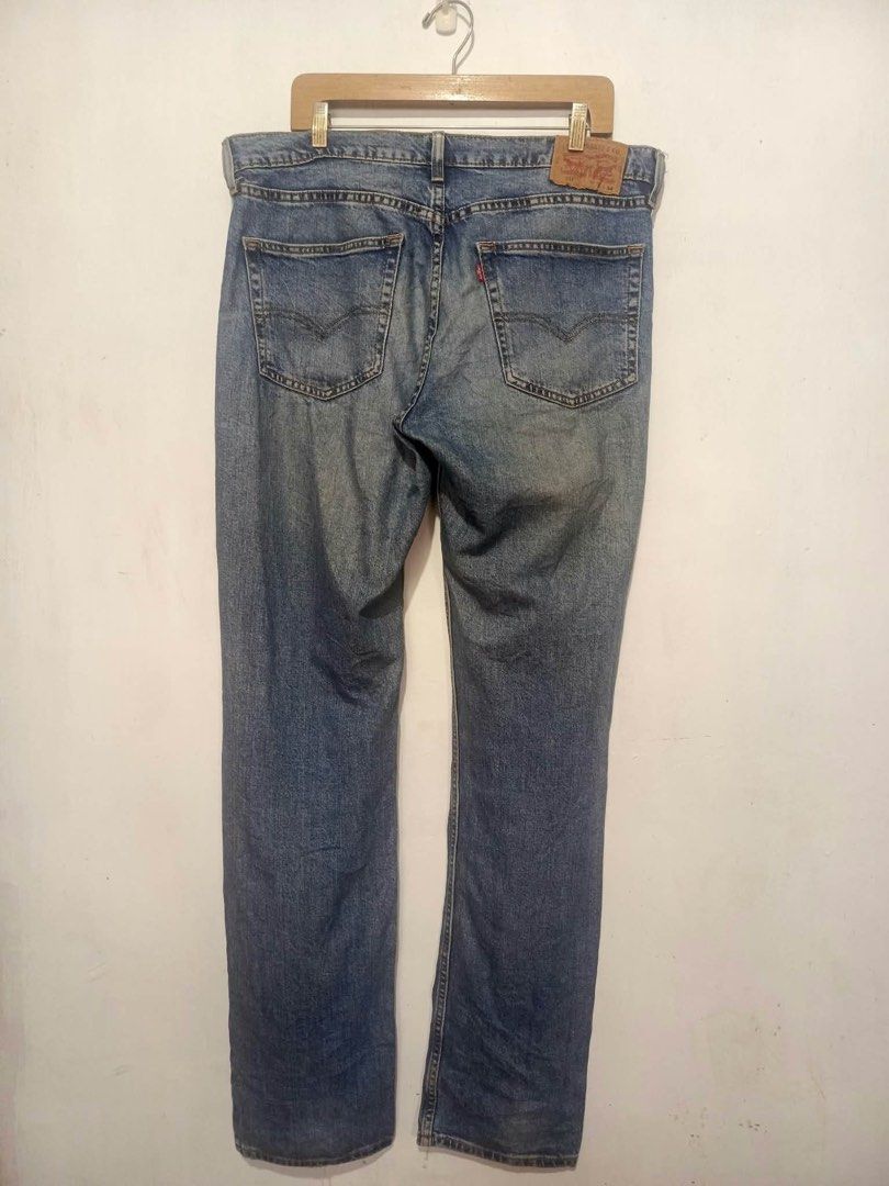 Levi's 511 Slim Fit Jeans W36 L34 (Category: Jeans) located in Baguio. Submitted by miisthyshop.ph (Listing ID 1469909577, Image 2). Description: - Brand: Levi's 511 Slim Fit Jeans - Size: W36 L34 - Color: Mid wash blue with faded details on thighs and knees - Closure: Classic button fly - Details: Five-pocket styling, leather back patch, and signature red tab - Material: Sturdy, comfortable denim ideal for everyday wear.