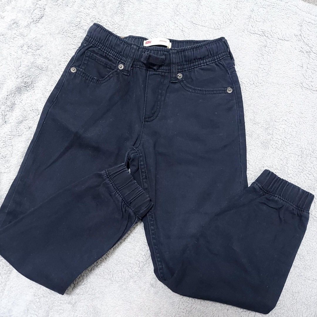 Levi's Boys Black Jogger Jeans Size 6 Regular (Category: Jeans) located in Caloocan City. Submitted by epicshark.da6ff7 (Listing ID 1469893094, Image 1). Description: - Brand: Levi's - Item: Boys Jogger Pants - Color: Dark Navy Blue - Size: 6 Regular (Fits ages 5-6 years / Height 110-116 cm) - Material: 98% Cotton, 2% Elastane - Features: Elastic waistband with drawstring, elasticized ankle cuffs, classic 5-pocket styling, and signature Levi's le