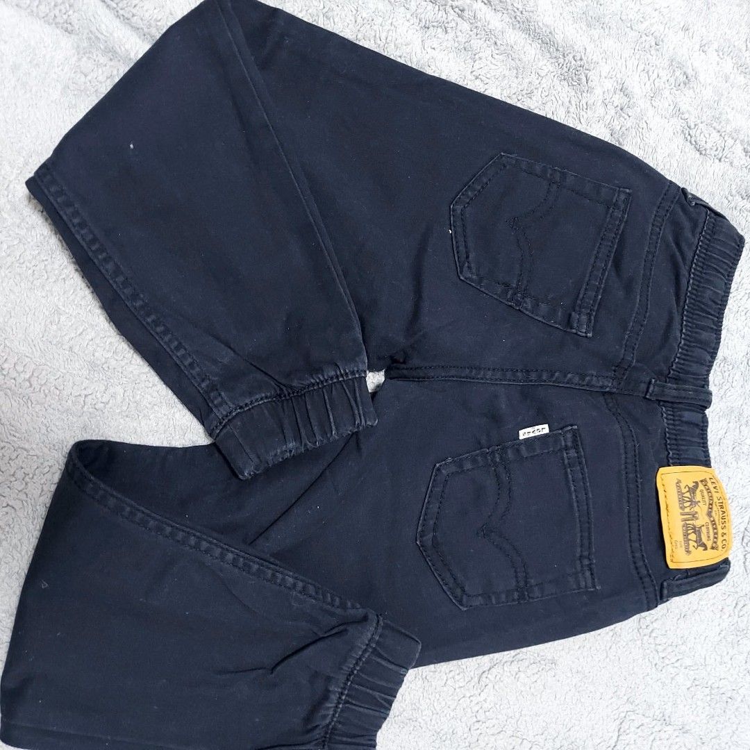 Levi's Boys Black Jogger Jeans Size 6 Regular (Category: Jeans) located in Caloocan City. Submitted by epicshark.da6ff7 (Listing ID 1469893094, Image 3). Description: - Brand: Levi's - Item: Boys Jogger Pants - Color: Dark Navy Blue - Size: 6 Regular (Fits ages 5-6 years / Height 110-116 cm) - Material: 98% Cotton, 2% Elastane - Features: Elastic waistband with drawstring, elasticized ankle cuffs, classic 5-pocket styling, and signature Levi's le