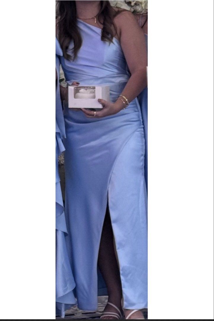 Light blue bridesmaid gown (Category: Dresses) located in Quezon City. Submitted by cencen610 (Listing ID 1469793165, Image 1). Description: - Color: Light blue - Material: Luxurious satin - Style: One-shoulder maxi dress with a sexy side slit - Back Details: Adjustable lace-up tie closure with extra-long straps for a customizable fit - Condition: Worn once for a wedding - Perfect for: Weddings, formal events, proms, or special occasions.