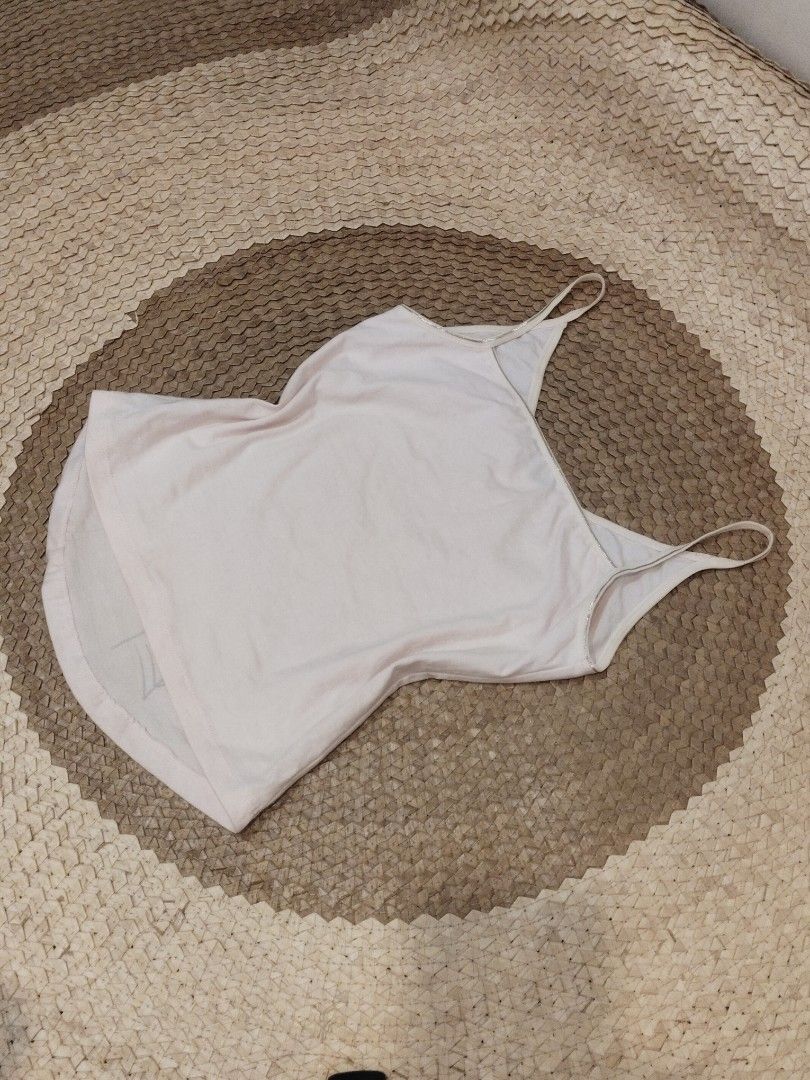 Light Pink Spaghetti Strap Camisole Tank Top (Category: Sleeveless) located in San Juan City. Submitted by rhennx (Listing ID 1469895479, Image 2). Description: - Color: Baby pink - No issue on print - Need wash (washable light stains) - Material: Soft cotton blend - Design: Thin spaghetti straps, scoop neckline - Fit: Relaxed fit, basic solid color - Versatility: Great for layering or wearing alone in warm weather.