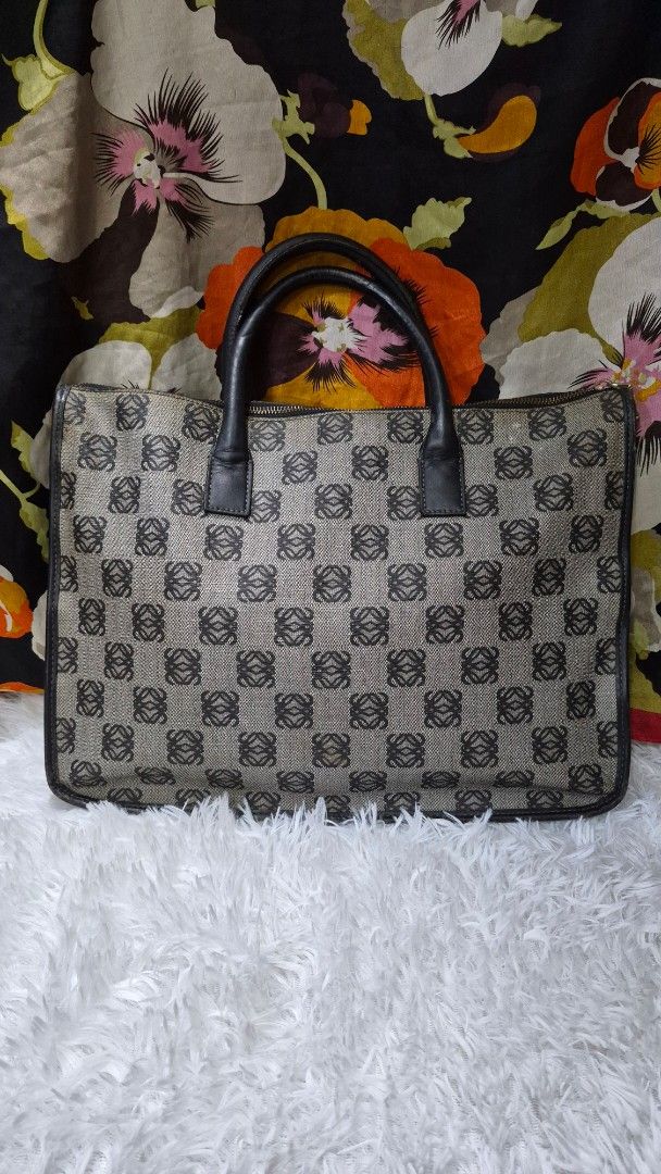 Loewe Anagram Canvas Document Case Handbag (Category: Luxury Bags & Wallets) located in Baguio. Submitted by jhaz_bags (Listing ID 1469902958, Image 2). Description: Vintage Loewe handbag in the classic Anagram monogram pattern. Grey canvas body with dark brown leather handles and piping. Gold-tone zipper closure across the top. Side D-rings attached for an optional strap. Structured rectangular shape, fits documents and daily essentials easily. 