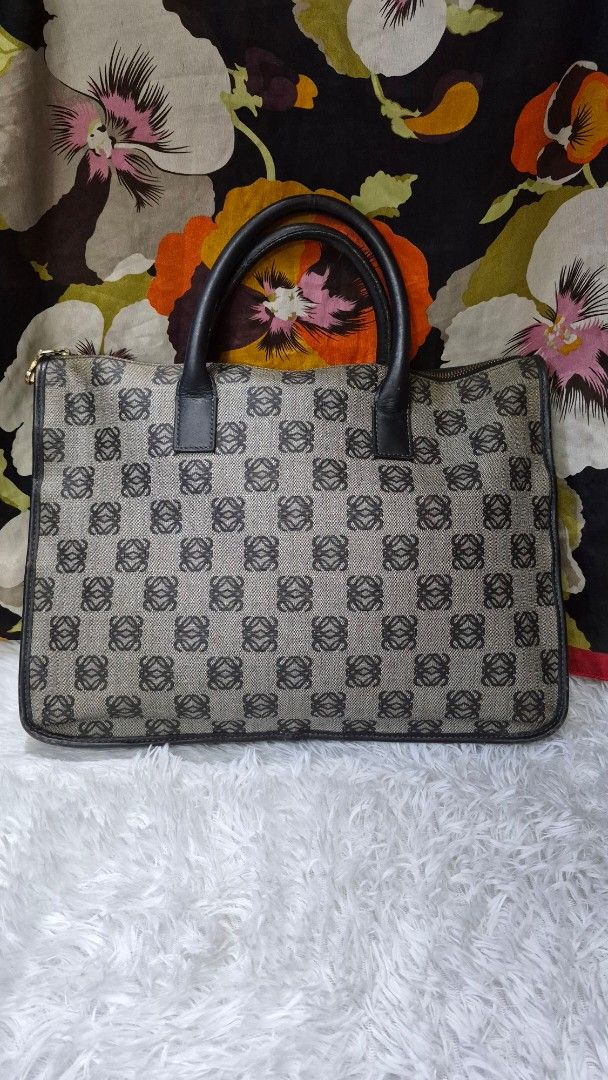 Loewe Anagram Canvas Document Case Handbag (Category: Luxury Bags & Wallets) located in Baguio. Submitted by jhaz_bags (Listing ID 1469902958, Image 1). Description: Vintage Loewe handbag in the classic Anagram monogram pattern. Grey canvas body with dark brown leather handles and piping. Gold-tone zipper closure across the top. Side D-rings attached for an optional strap. Structured rectangular shape, fits documents and daily essentials easily. 