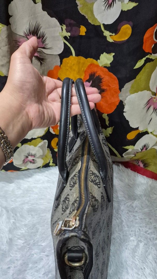 Loewe Anagram Canvas Document Case Handbag (Category: Luxury Bags & Wallets) located in Baguio. Submitted by jhaz_bags (Listing ID 1469902958, Image 3). Description: Vintage Loewe handbag in the classic Anagram monogram pattern. Grey canvas body with dark brown leather handles and piping. Gold-tone zipper closure across the top. Side D-rings attached for an optional strap. Structured rectangular shape, fits documents and daily essentials easily. 
