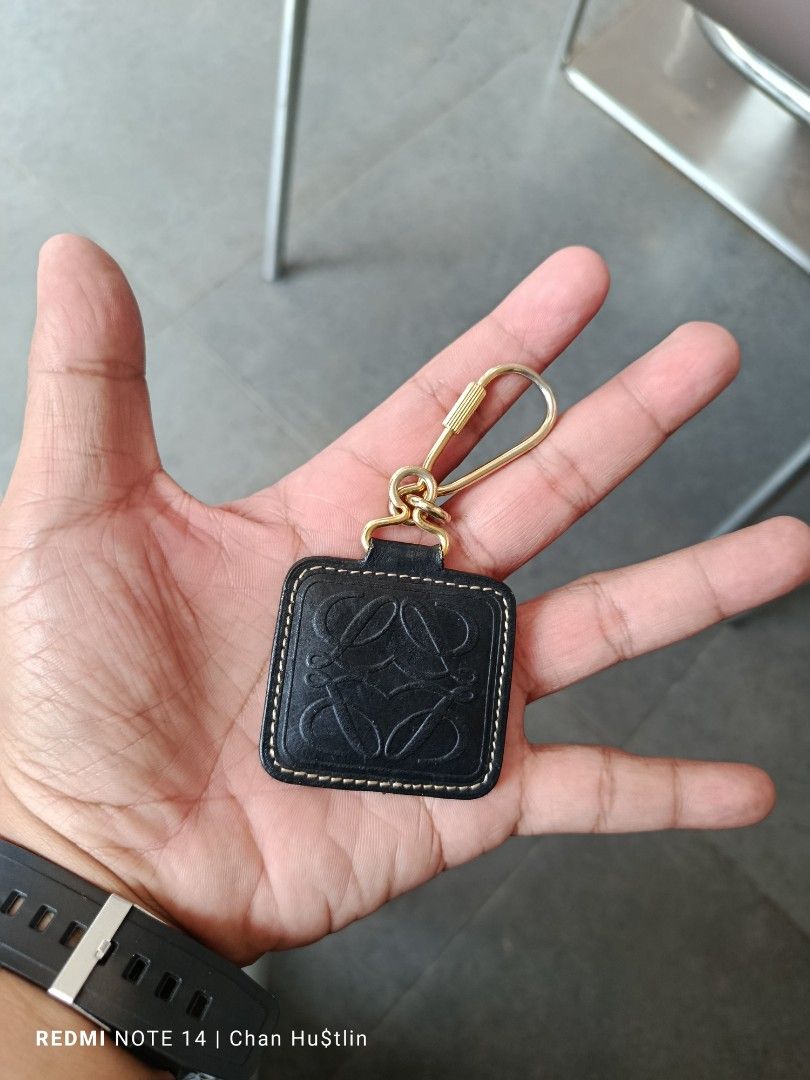 Loewe leather keychain black gold hardware (Category: Luxury Accessories) located in Calamba. Submitted by chanmagpantay (Listing ID 1469770745, Image 2). Description: - Authentic Loewe black leather keychain - Features iconic embossed Anagram logo and stylish contrast white stitching - Premium gold-tone metal hardware with a secure clip closure - Compact size, perfect for accessorizing keys or bags - Condition: Shows minor signs of use on the le