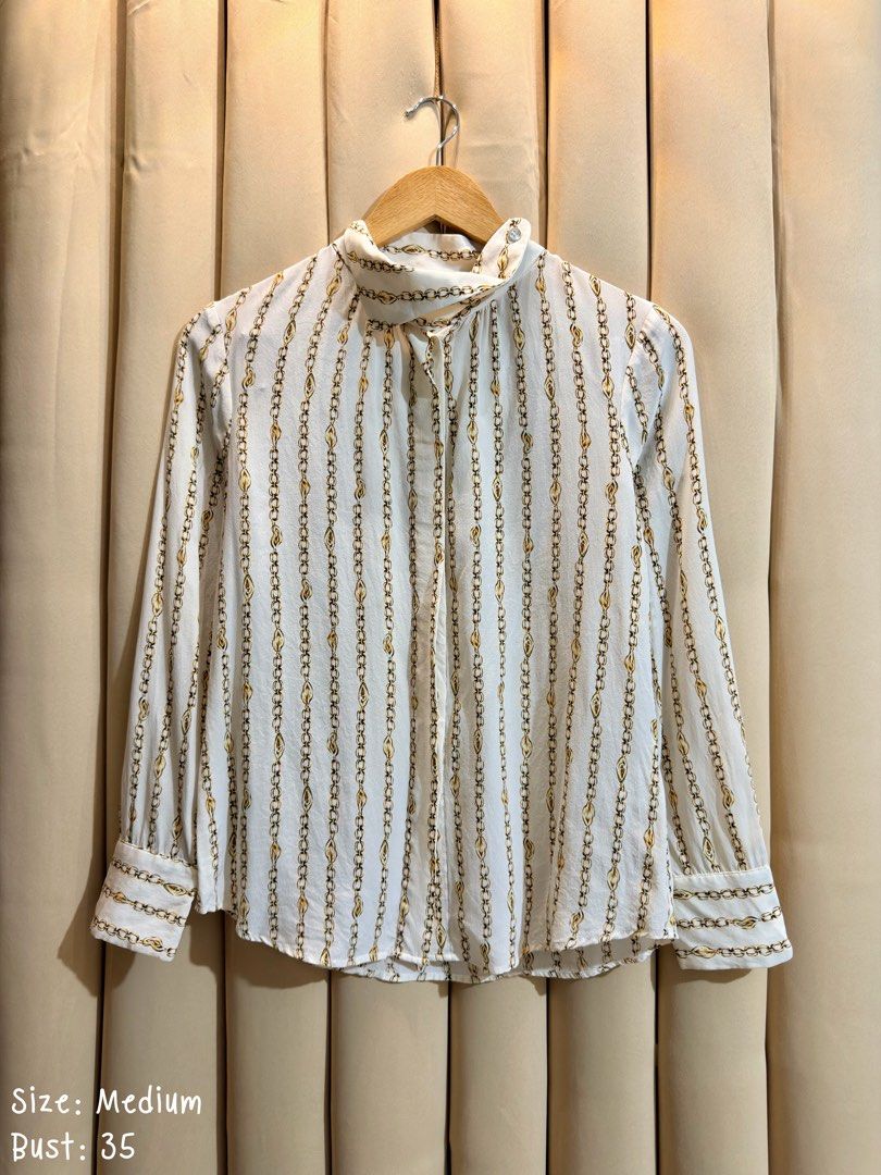 LONG SLEEVE BLOUSE (Category: Blouses) located in Manila. Submitted by glamstylemnl (Listing ID 1469916428, Image 1). Description: ♡ SIZE: M ♡ BUST: 35 ♡ Swipe left to see the actual color & details ♡ vertical gold chain and link pattern, mock neck ♡ HQ • 10/10 ♡ Ready to wear 👚.