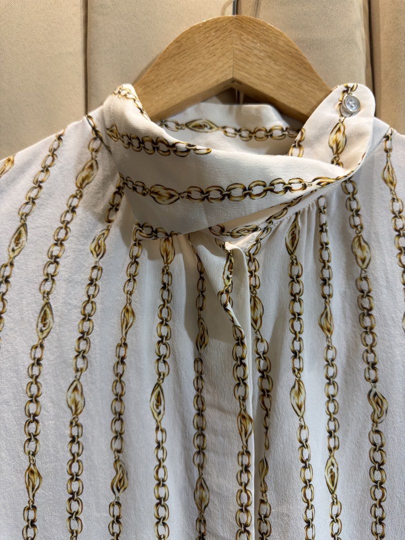 LONG SLEEVE BLOUSE (Category: Blouses) located in Manila. Submitted by glamstylemnl (Listing ID 1469916428, Image 2). Description: ♡ SIZE: M ♡ BUST: 35 ♡ Swipe left to see the actual color & details ♡ vertical gold chain and link pattern, mock neck ♡ HQ • 10/10 ♡ Ready to wear 👚.
