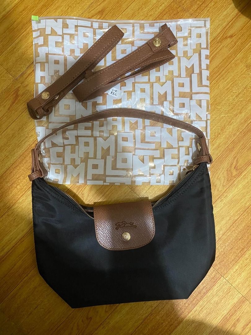 Longchamp Le Pliage black nylon shoulder bag with strap (Category: Luxury Bags & Wallets) located in Caloocan City. Submitted by alodiaveni09874 (Listing ID 1469947078, Image 1). Description: - Brand: Longchamp - Color: Classic black nylon with rich brown leather trim - Hardware: Elegant gold-tone - Closure: Secure top zipper - Shape: Versatile and lightweight hobo style - Inclusions: Brand new detachable brown leather strap in original transpare
