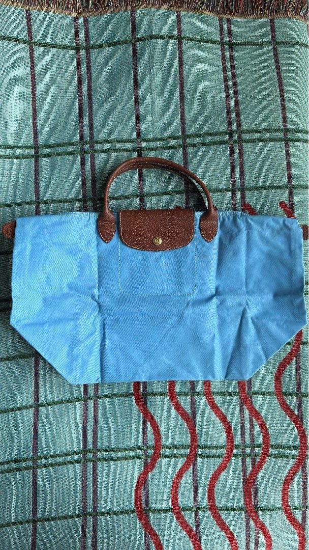 Longchamp Le Pliage Original Short Handle Tote – Light Blue (Category: Luxury Bags & Wallets) located in Quezon City. Submitted by sr.archive (Listing ID 1469797768, Image 1). Description: Classic brown leather top handle, flap, and gold-tone snap button closure Condition note: Has some spots and stains on the fabric exterior from previous use and storage (priced accordingly).
