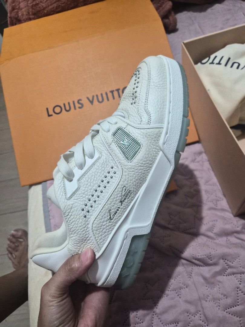 Louis Vuitton LV Trainer White Studded Sneakers (Category: Sneakers) located in Cabuyao City. Submitted by ecargchi22 (Listing ID 1469773434, Image 1). Description: - Brand: Louis Vuitton - Style: Grained leather trainers with metallic stud embellishments - Inclusions: Original orange box, dust bag, and receipt paperwork - Details: Signature LV branding on the tongue and side, translucent outsoles with debossed lettering - Shipping & Meetups: Fas
