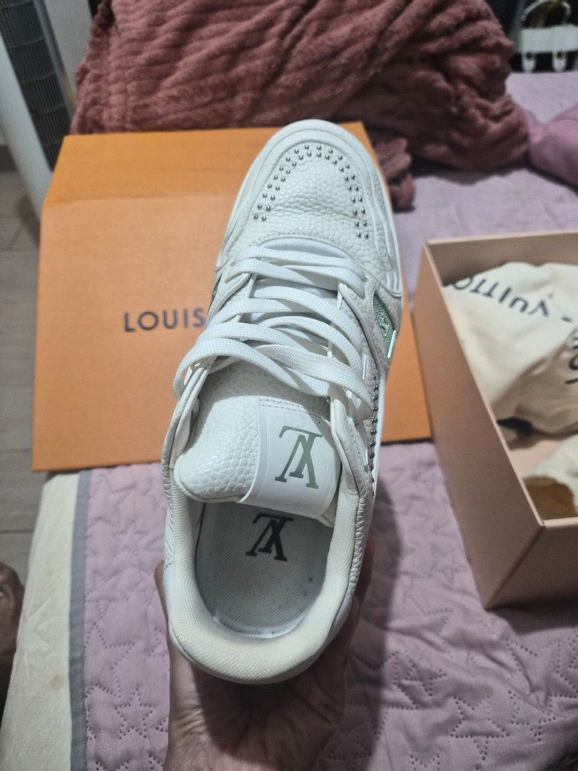 Louis Vuitton LV Trainer White Studded Sneakers (Category: Sneakers) located in Cabuyao City. Submitted by ecargchi22 (Listing ID 1469773434, Image 3). Description: - Brand: Louis Vuitton - Style: Grained leather trainers with metallic stud embellishments - Inclusions: Original orange box, dust bag, and receipt paperwork - Details: Signature LV branding on the tongue and side, translucent outsoles with debossed lettering - Shipping & Meetups: Fas