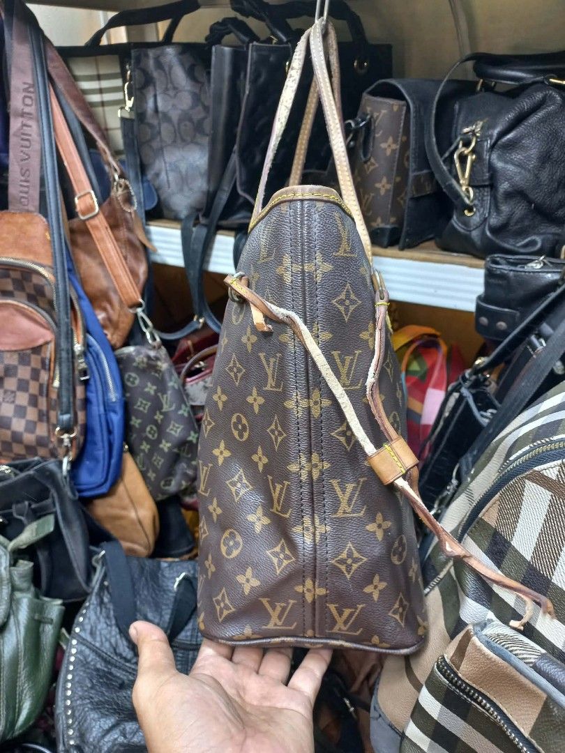 Louis Vuitton Monogram Canvas Tote Bag (Category: Luxury Bags & Wallets) located in Manila. Submitted by dei03_diz (Listing ID 1469880671, Image 3). Description: - Classic monogram canvas tote with brown leather handles and trim - Open top design featuring adjustable side cinch laces - Spacious interior lined with durable striped fabric and gold-tone hardware - Clean canvas body with normal leather darkening and wear around the edges from regular